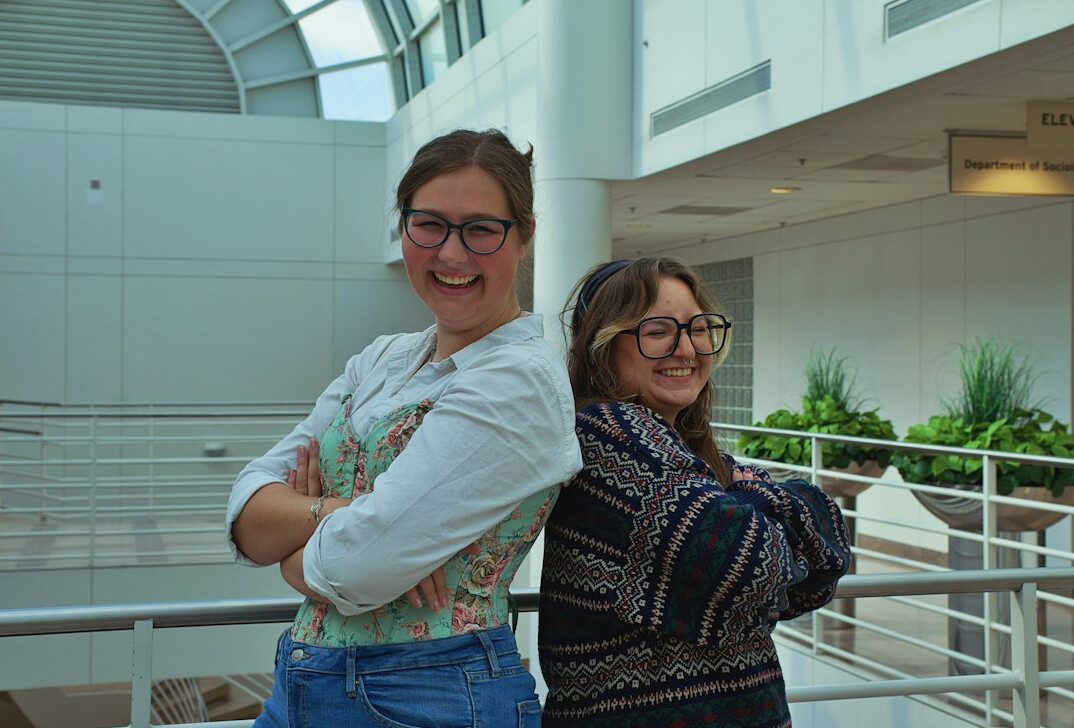 Colleagues smiling together around a desk