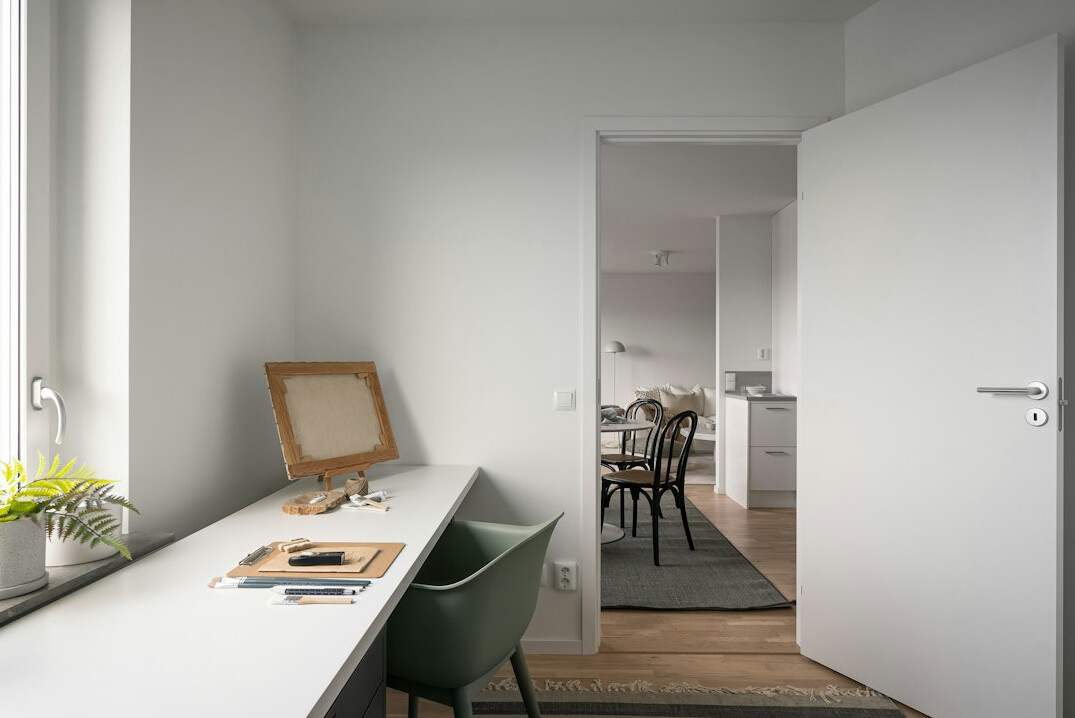 Wooden desk with laptop notebook and coffee cup seen from above